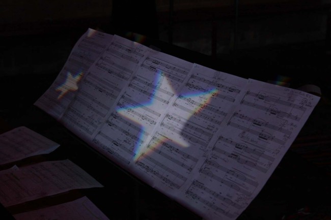 Score of 'By the Water' lit up with the incredible light design work.