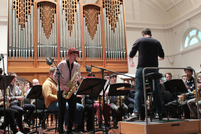 Rehearsal of Mark Phillips's saxophone concerto What If? for 100 saxes.